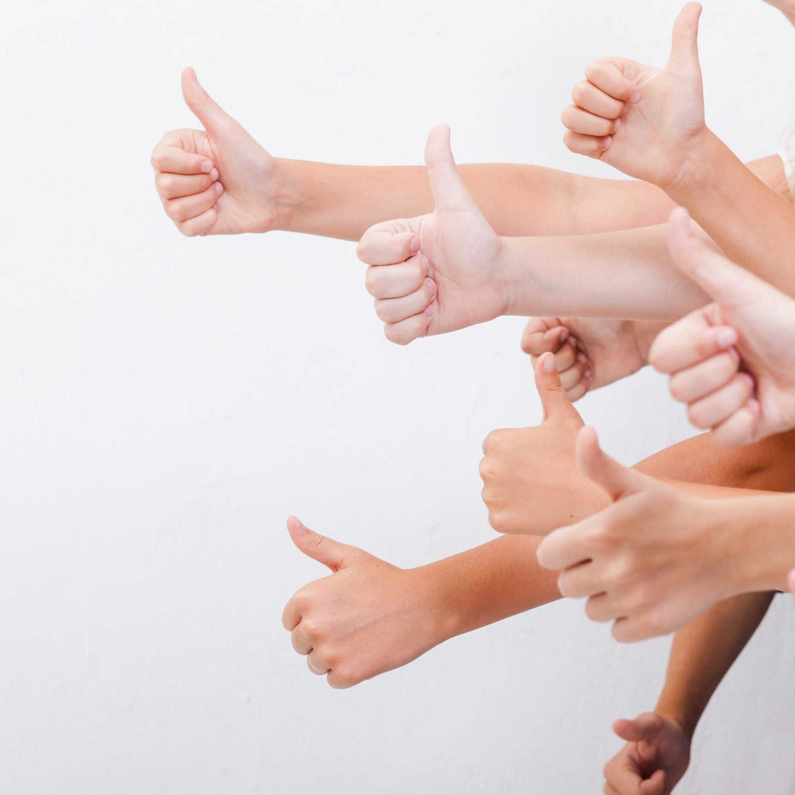 hands of teenagers showing okay sign on white